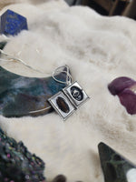Crow vertebrae and feather locket