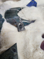 Crow vertebrae and feather locket