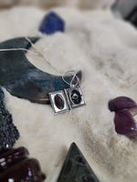 Crow vertebrae and feather locket
