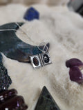 Crow vertebrae and feather locket