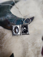 Crow vertebrae and feather locket
